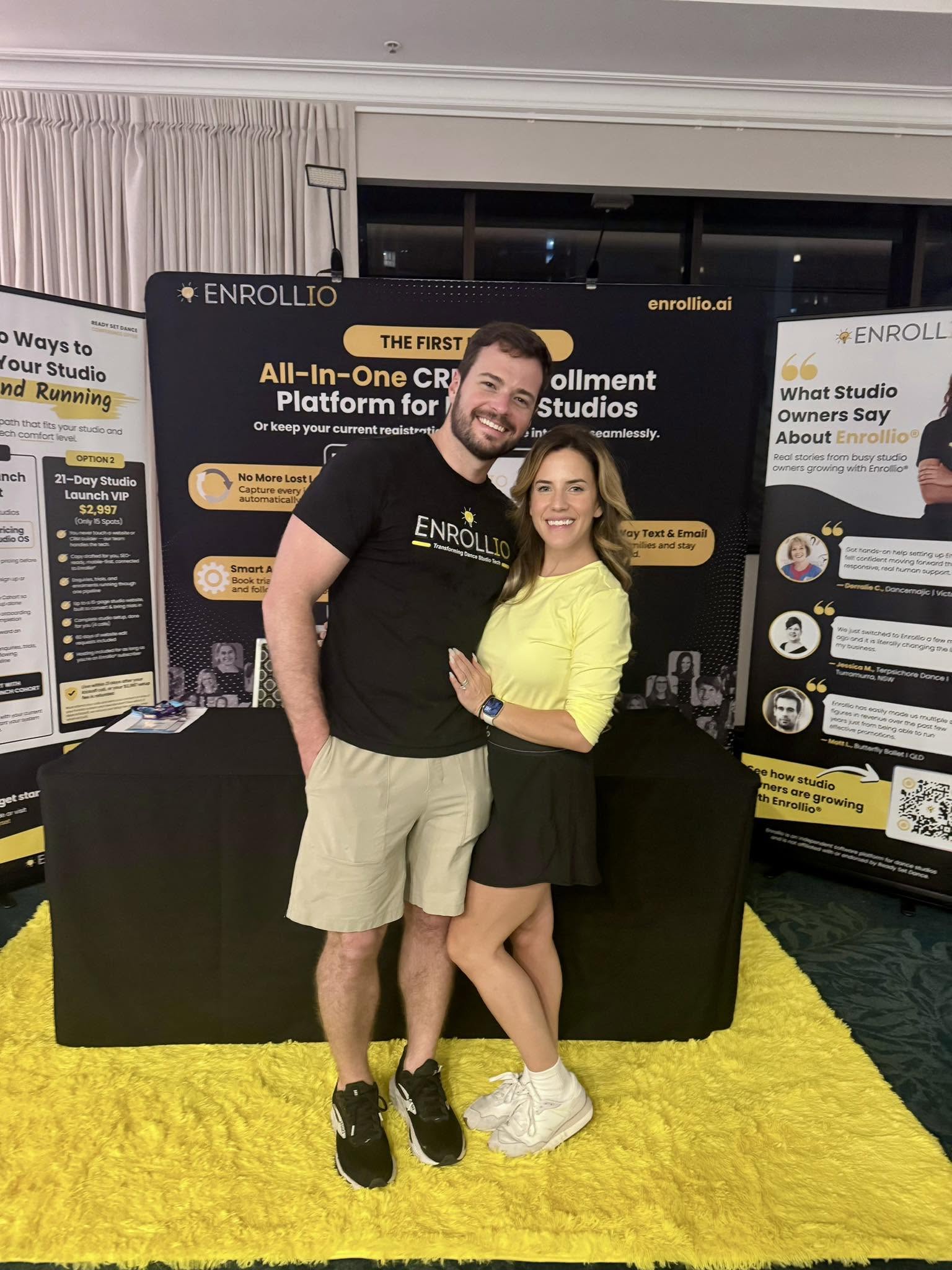 Brad and Hope, the founders of Enrollio, standing together at an Enrollio conference booth